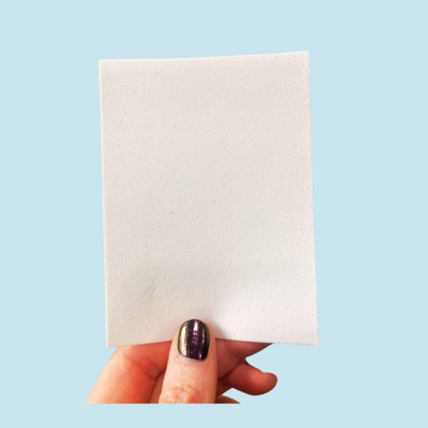 Fingers holding up Laundry Detergent Sheet - Contact Wicked Wash to Order Eco-Friendly Laundry Detergent Sheets.